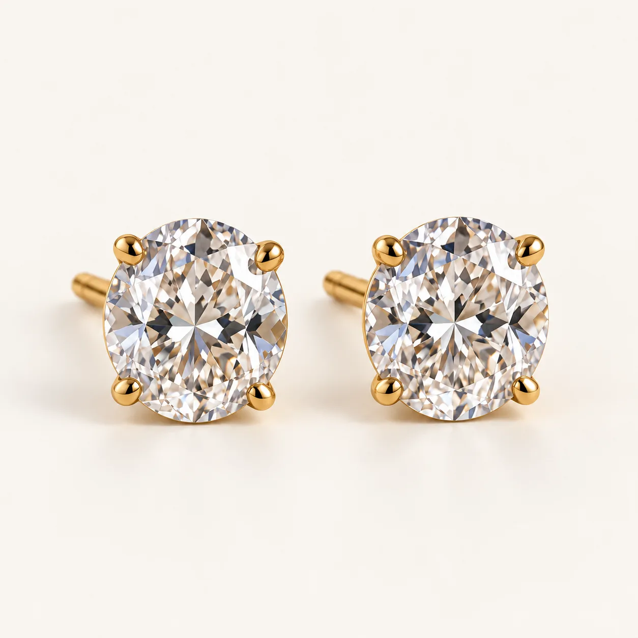 Oval diamond stud earrings in yellow gold