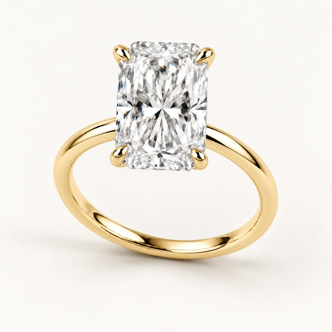 Radiant-cut diamond solitaire ring in yellow gold