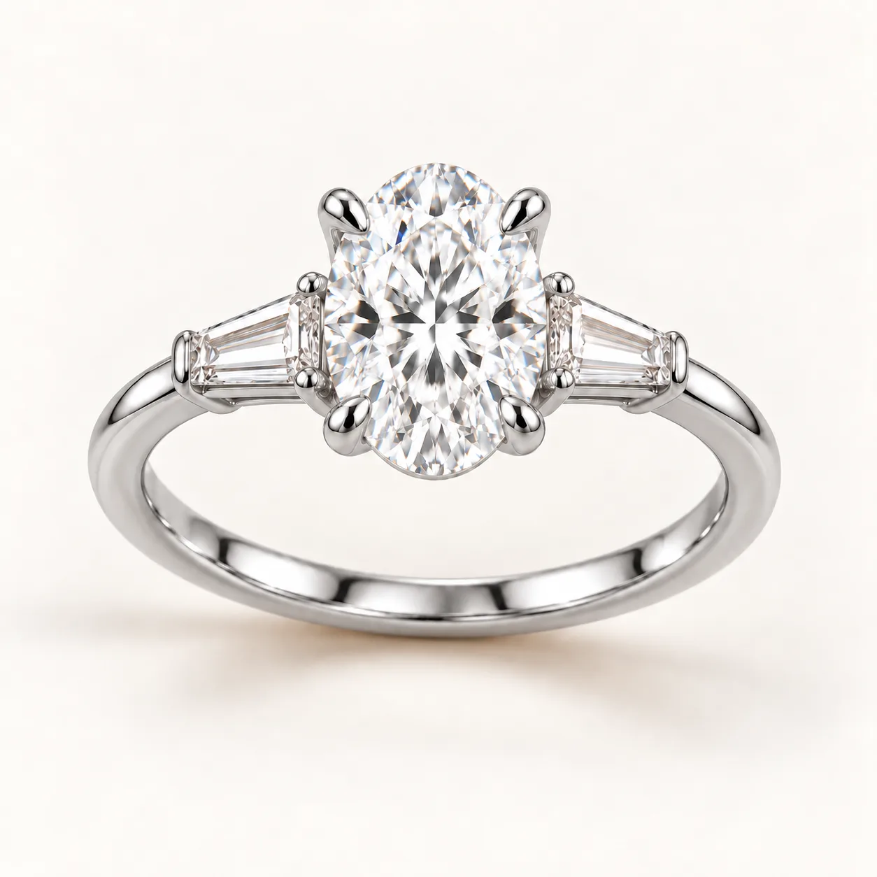 Oval diamond three-stone ring with tapered baguettes in platinum