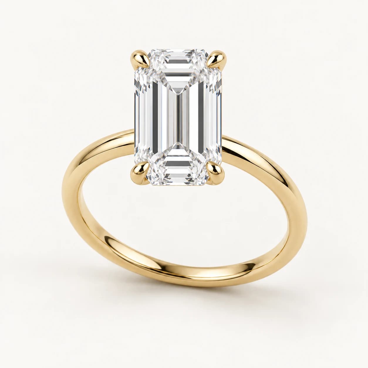 Emerald-cut diamond solitaire ring in yellow gold