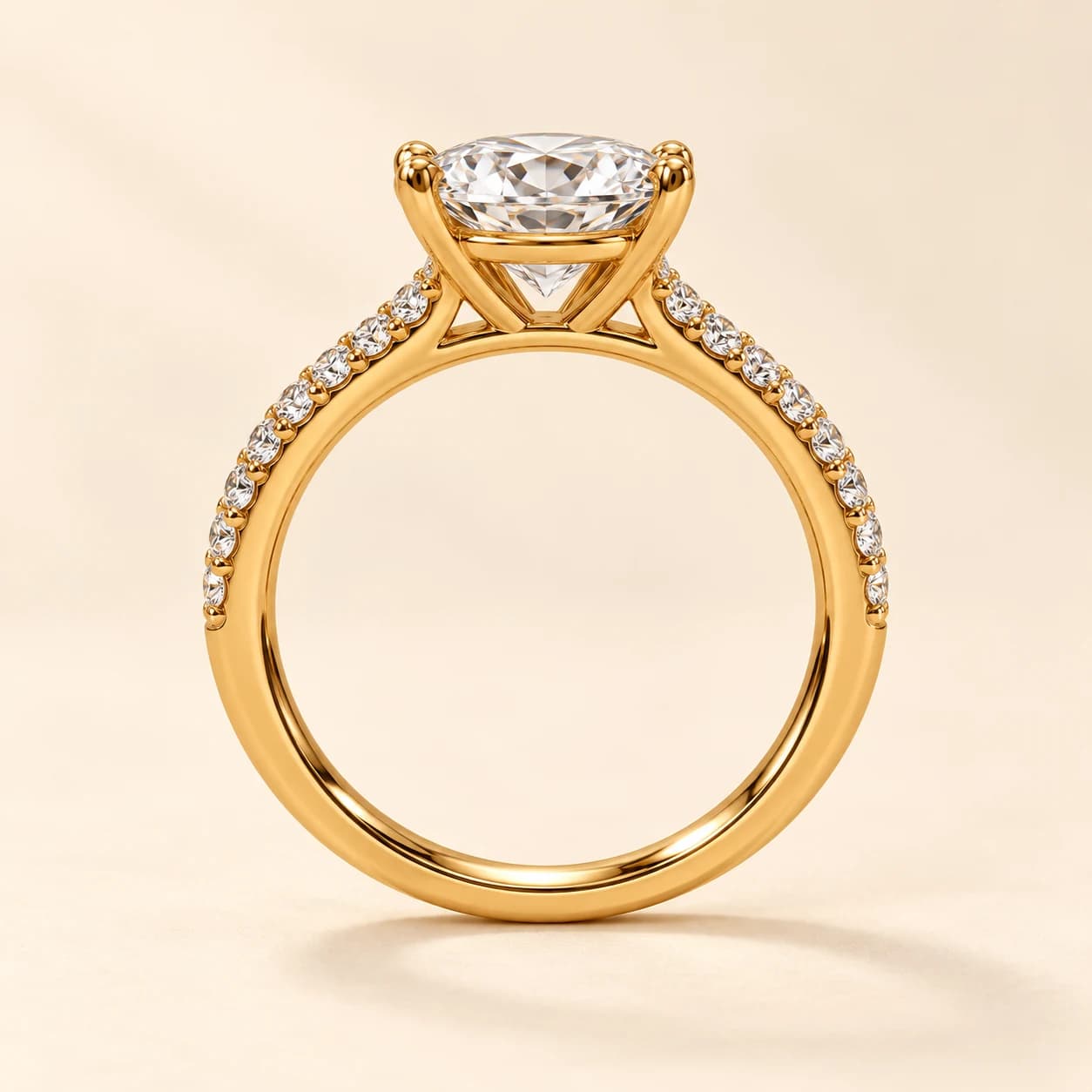 Oval pavé engagement ring in yellow gold, side profile showing the cathedral setting